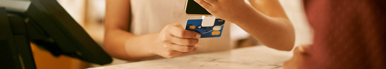 Woman swiping card on mobile reader.