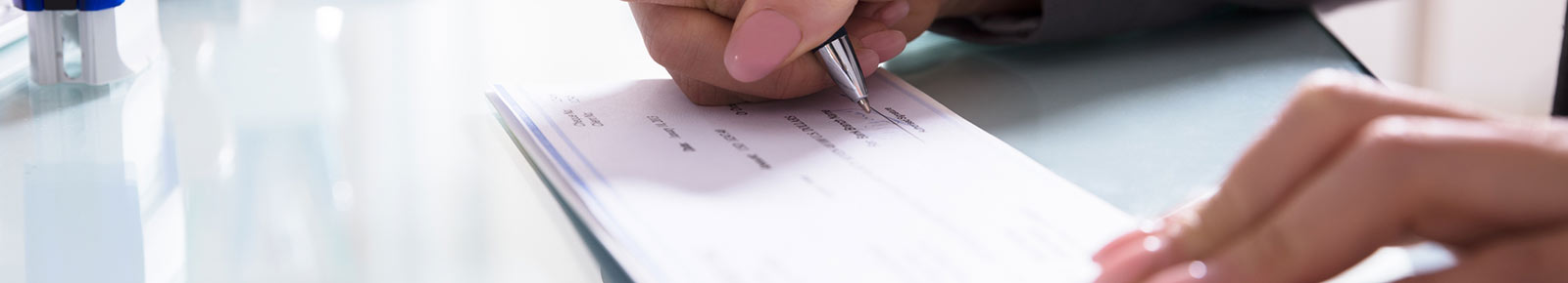 Woman writing business check.