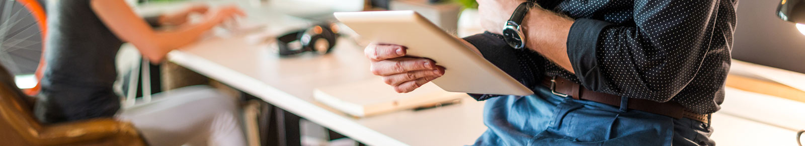 Man holding tablet at office.